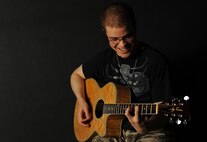 Senior Airman David Gonzalez, 791st Missile Security Forces Squadron defender, plays guitar at Minot Air Force Base, N.D., June 2, 2014. With strong musical talent, Gonzalez plans to pursue a career in music after his enlistment. (U.S. Air Force photo/Airman 1st Class Apryl Hall)