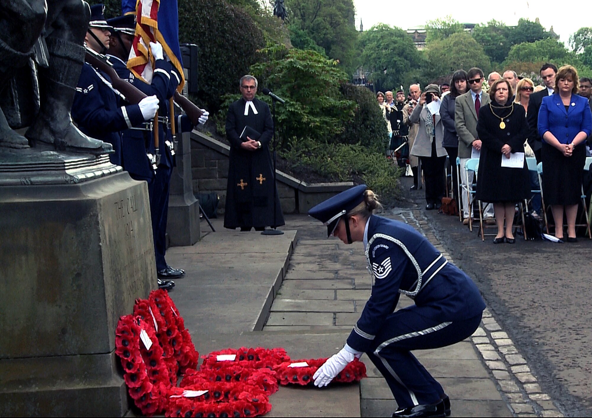 Technical Sgt. Stephanie Contreras, RAF Lakenheath Honor Guard NCO in charge, lays a wreath before “The Call” monument during the 80th Scottish-American Memorial Day service at West Princes Street Gardens, Scotland, May 26, 2014.  The ceremony was held to commemorate the Scottish-American soldiers who sacrificed their lives during the Great War. (U.S. Air Force photo by Airman 1st Class Amanda Sampson/Released)