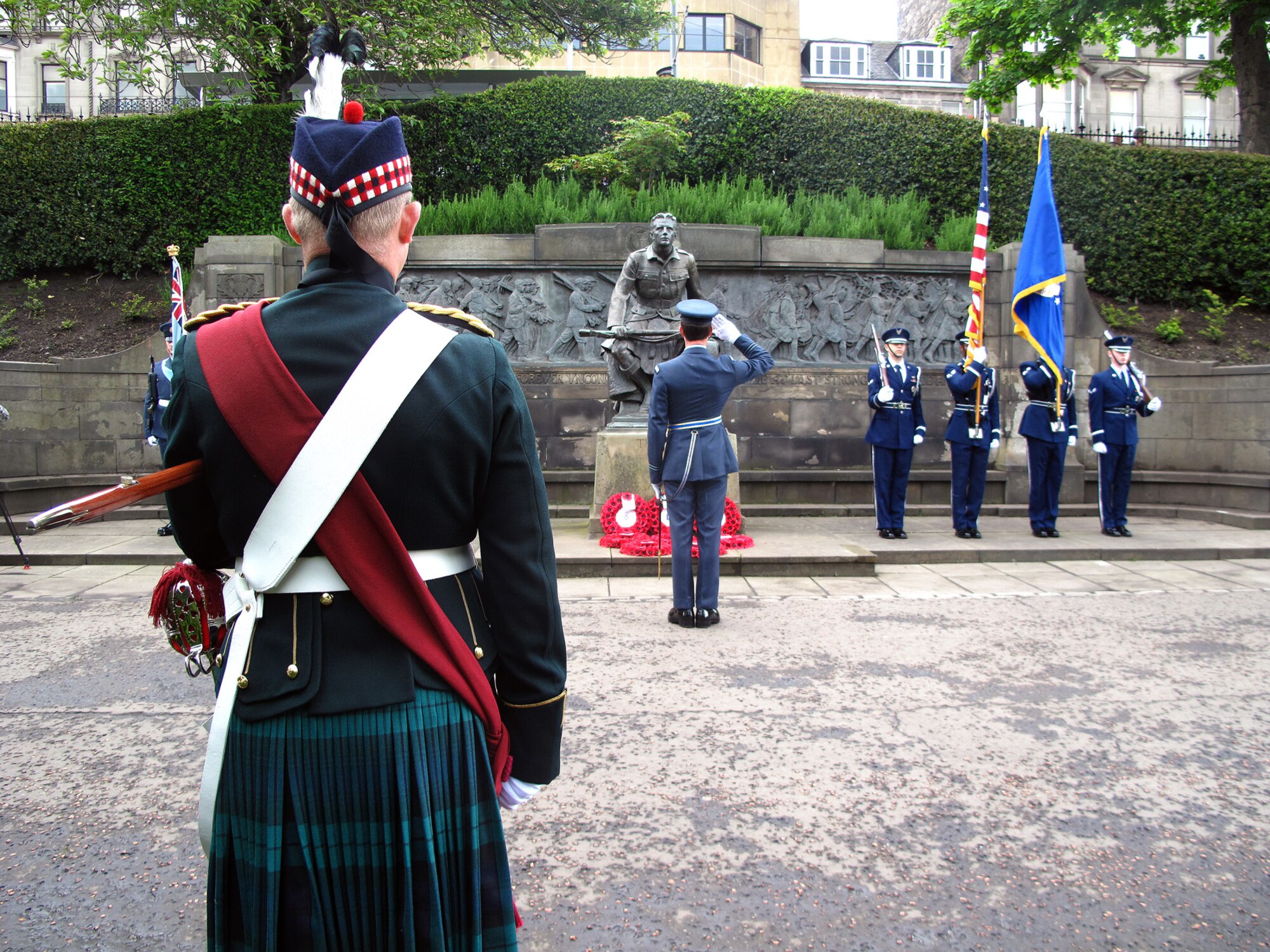 Royal Air Force Flt. Lt. D.R. Ford, Queen’s Colour Squadron, salutes “The Call” monument during the 80th Scottish-American Memorial Day Service at West Princes Street Gardens, Scotland, May 26, 2014. The ceremony was held to commemorate the Scottish-American soldiers who sacrificed their lives during the Great War. (Courtesy photo)