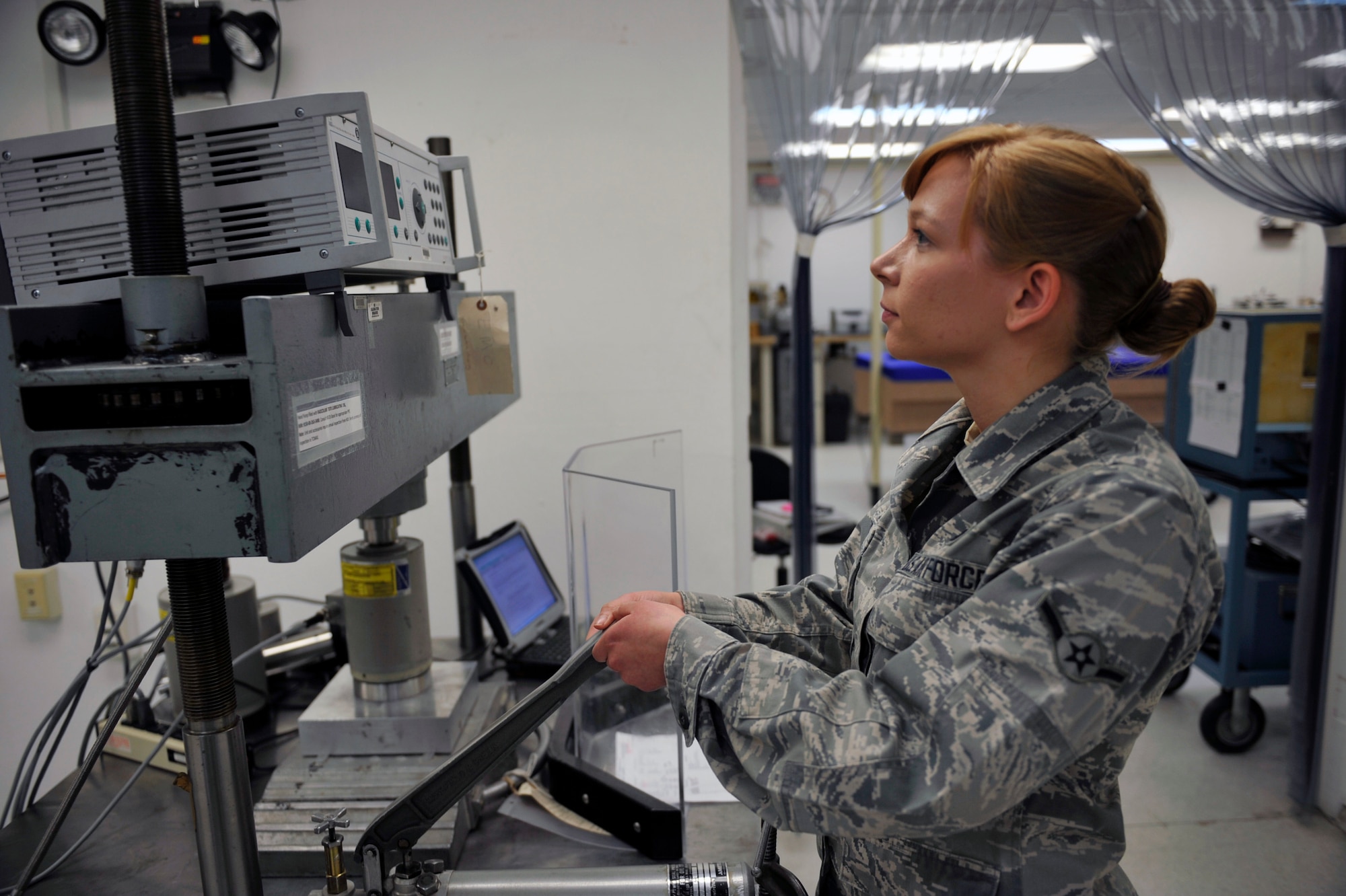 Airman Diana LeGro, 51st Maintenance Squadron precision measurement equipment laboratory technician, uses a force press to generate 20,000 lbs. of force to calibrate a wheel load weigher on Osan Air Base, Republic of Korea, May 20, 2014. LeGro is this week’s Airman Spotlight winner. (U.S. Air Force photo by Senior Airman David Owsianka)