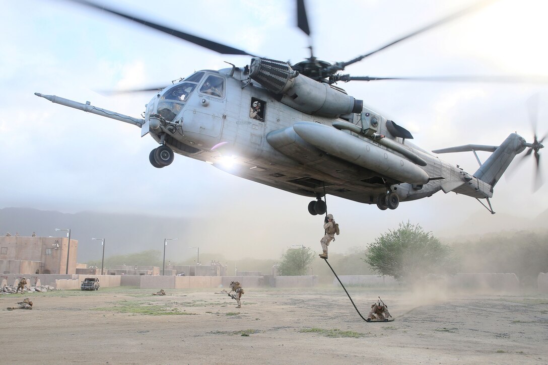 Marines rappel from a CH53E Super Stallion helicopter in an urban training area during Exercise Island Viper on Marine Corps Base Hawaii, Kaneohe Bay, Hawaii, May 28, 2014. The Marines, assigned to 2nd Platoon, India Company, 3rd Battalion, 3rd Marine Regiment, conducted the amphibious, offensive, and stability operation, which developed small unit level leadership and increased their lethality and ability to fight whenever the battalion is called upon.