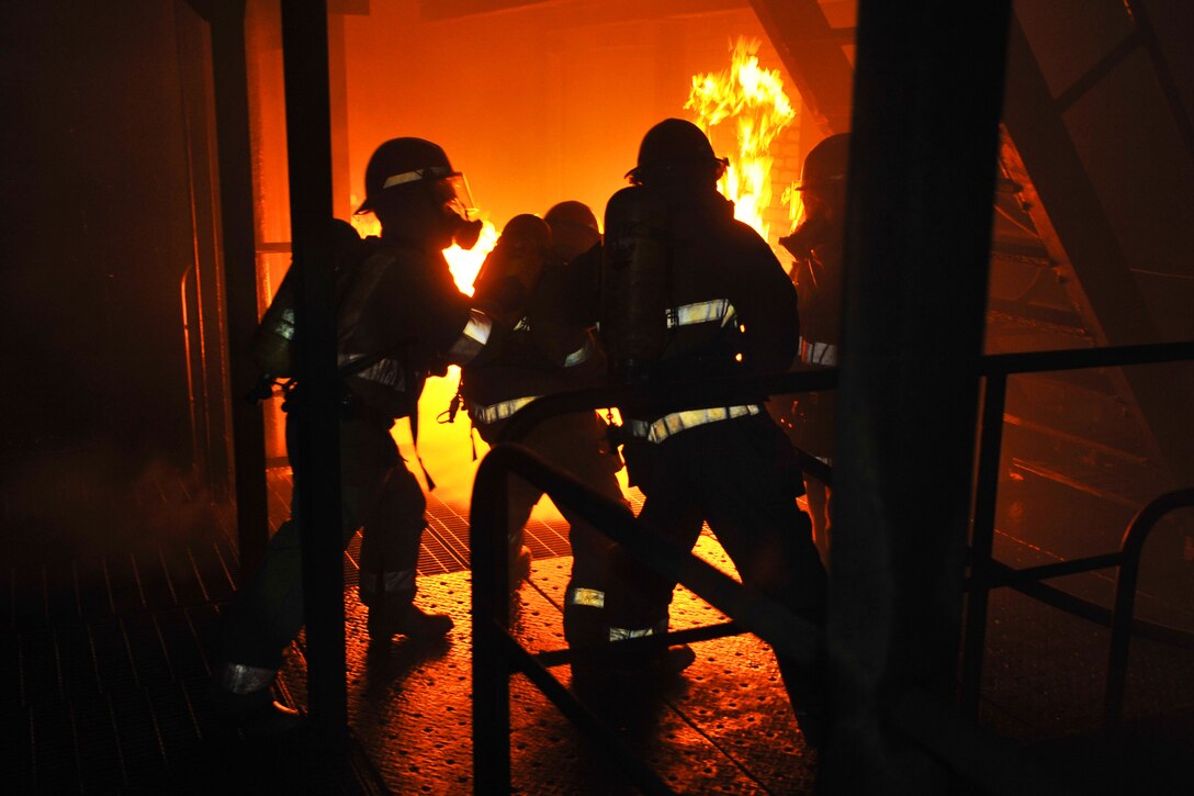 U.S. Navy sailors practice shipboard firefighting during an advanced damage control class at the Yokosuka Center for Naval Engineering Firefighting School at Commander Fleet Activities Yokosuka, April 12, 2012. The sailors are assigned to the aircraft carrier USS George Washington.  
