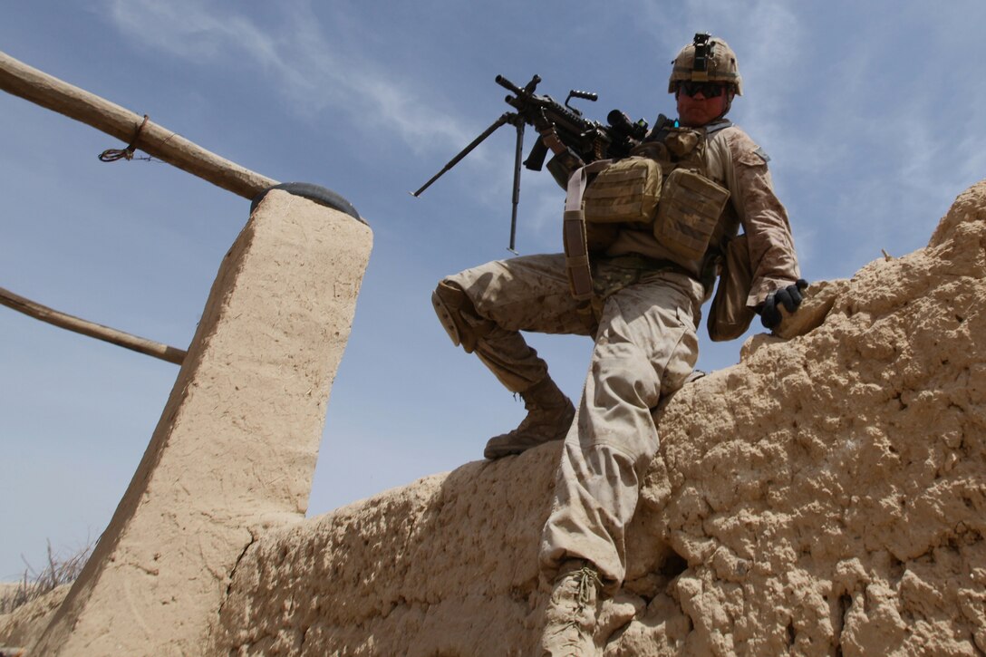 U.S. Marine Corps Lance Cpl. Sergey Huber clears a 7-foot wall during a regimental operation in Urmoz, Afghanistan, March 25, 2012. Huber is an automatic weapon gunner assigned to Alpha Company, 1st Battalion, 8th Marine Regiment.  
