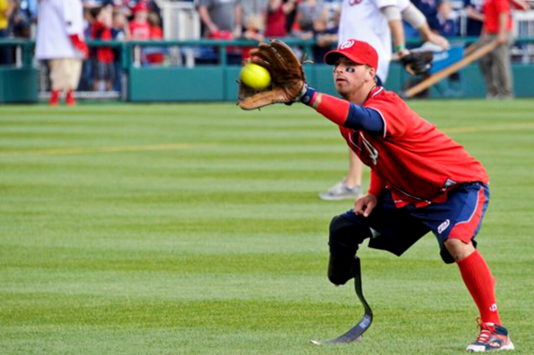 A wounded warrior makes the catch during warm up before the Amputee Softball Team exhibition game at Washington Nationals Stadium in Washington, D.C., April 3, 2012.  
