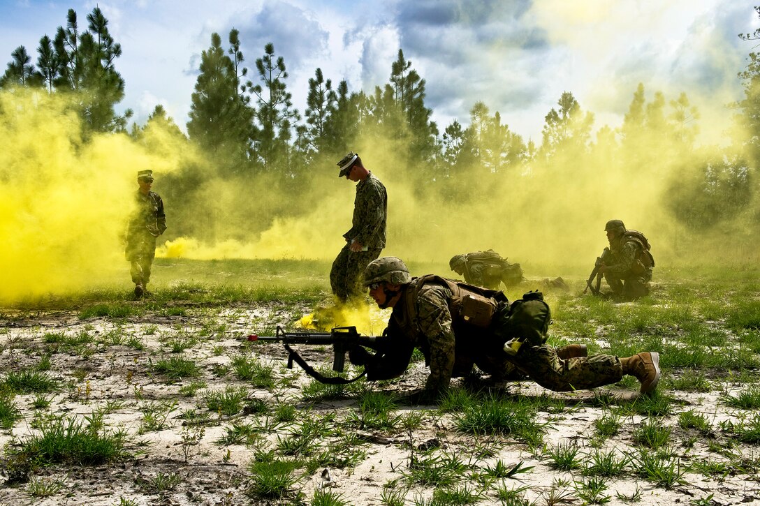 Navy Seabees react to small arms fire during a training exercise on Camp Shelby, Miss., March 19, 2012. The exercise provides a robust training environment where Seabee forces plan and execute essential mission tasks before deployment. The Seabees are assigned to Naval Mobile Construction Battalion 74.  
