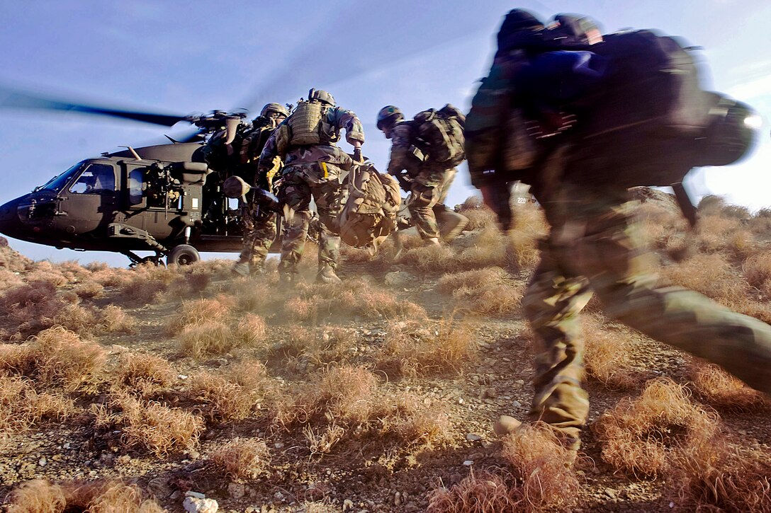 Afghan commandos sprint to board a U.S. Army UH-60 Black Hawk helicopter during a mission in the Chawkai district in Afghanistan's Kunar province, Feb. 25, 2012. The commando-led mission was to conduct reconnaissance for a future village stability platform where Afghan forces and coalition special operations forces can live and work with villagers.  

