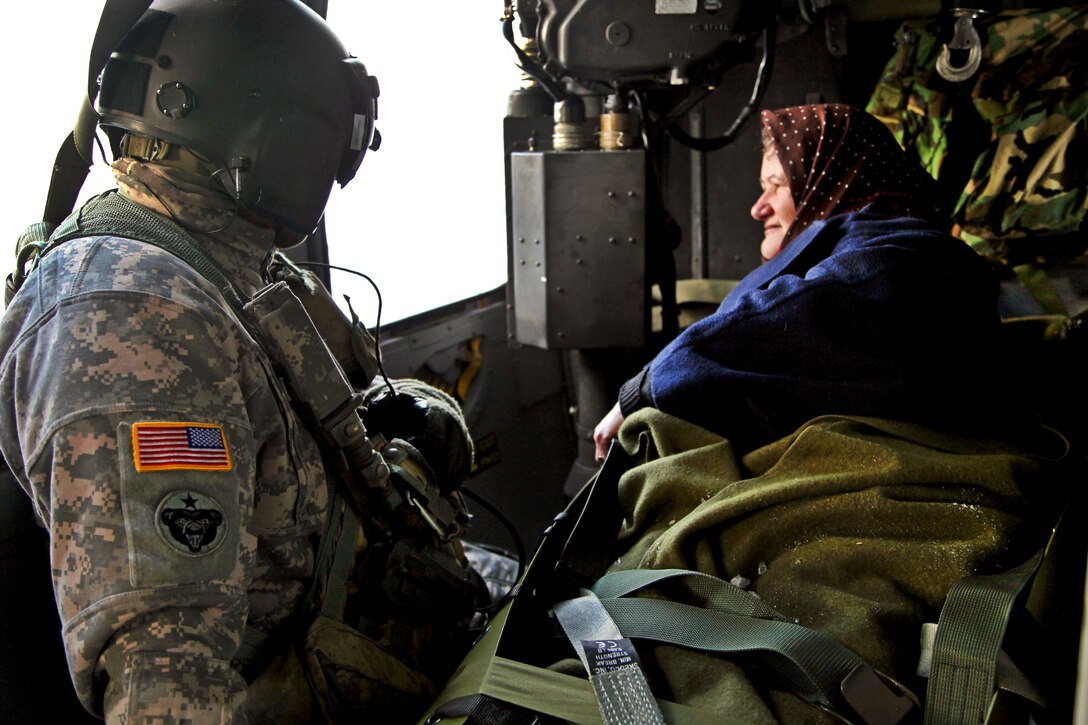 U.S. Army Staff Sgt. Gerald Winchester monitors a Montenegrin citizen during an air medical evacuation over Podgorica, Montenegro, Feb. 28, 2012. U.S. soldiers helped provide humanitarian assistance at the request of Montenegro's government in response to heavy snowfall in the region.U.S. Army photo by Sgt. Edwin Bridges  
