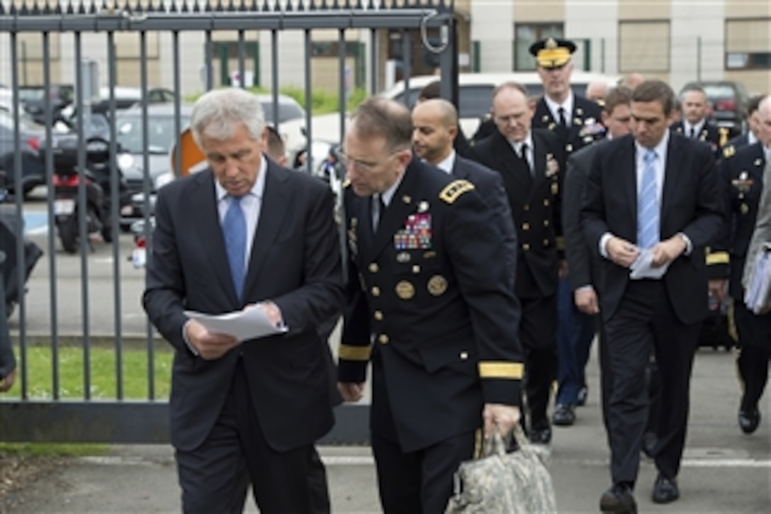 U.S. Defense Secretary Chuck Hagel, left, speaks with U.S. Army Lt. Gen. Robert B. Abrams, his senior military assistant, before the first session of the North Atlantic Council at NATO headquarters in Brussels, June 3, 2014. 