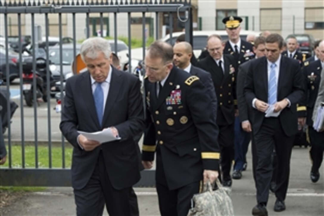 U.S. Defense Secretary Chuck Hagel, left, speaks with U.S. Army Lt. Gen. Robert B. Abrams, his senior military assistant, before the first session of the North Atlantic Council at NATO headquarters in Brussels, June 3, 2014. 