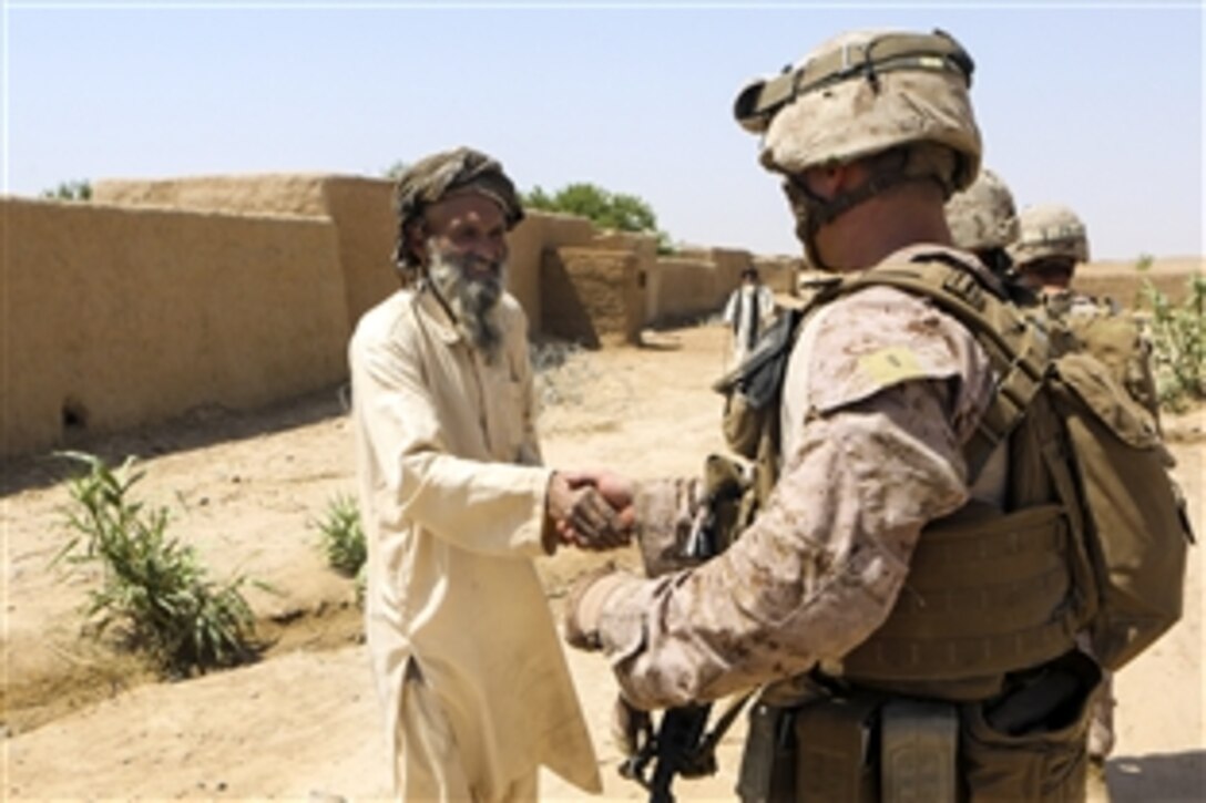 U.S. Marines Corps 2nd Lt. Michael Bressler shakes hands with an Afghan elder during a security patrol near the town of Boldak in Helmand province, Afghanistan, May 21, 2014. Bressler, a platoon commander, is assigned to 1st Battalion, 2nd Marine Regiment.