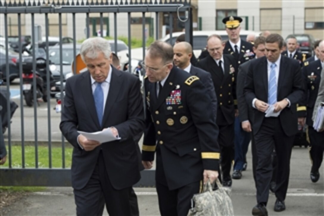 U.S. Defense Secretary Chuck Hagel, left, speaks with U.S. Army Lt. Gen. Robert B. Abrams, his senior military assistant, before the first session of the North Atlantic Council at NATO headquarters in Brussels, June 3, 2014. 
