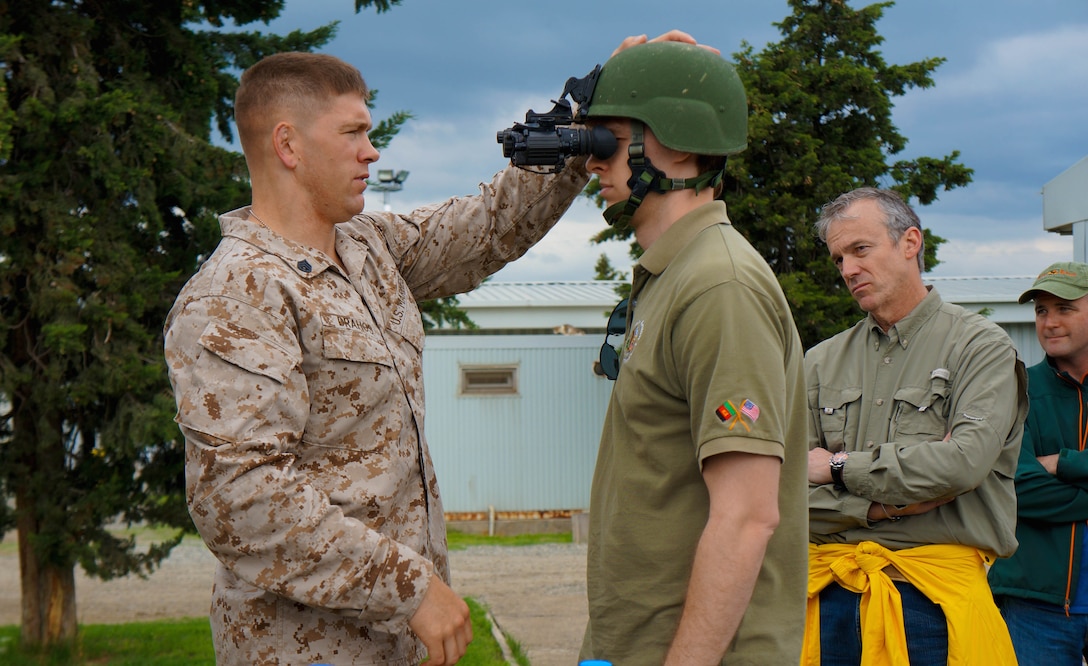 Before a night-vision course, Staff Sgt. Jesse Drahos, a Marine with the Georgia Deployment Program-ISAF, fits a night-vision device, the PVS-14, on a U.S. Embassy staff member of the U.S. Embassy in Georgia, during an Embassy Training Day at the Krtsanisi National Training Centre, outside of Tbilisi, May 8. To provide a snapshot into the lives of U.S. Marines and Georgian soldiers of GDP-I, civilian embassy staff participated in basic-infantry experiences during the event. The Marine Forces Europe and Africa-led program has trained Georgian battalions to support ISAF missions in Afghanistan, serving alongside U.S. and other partner-nation’s forces. 