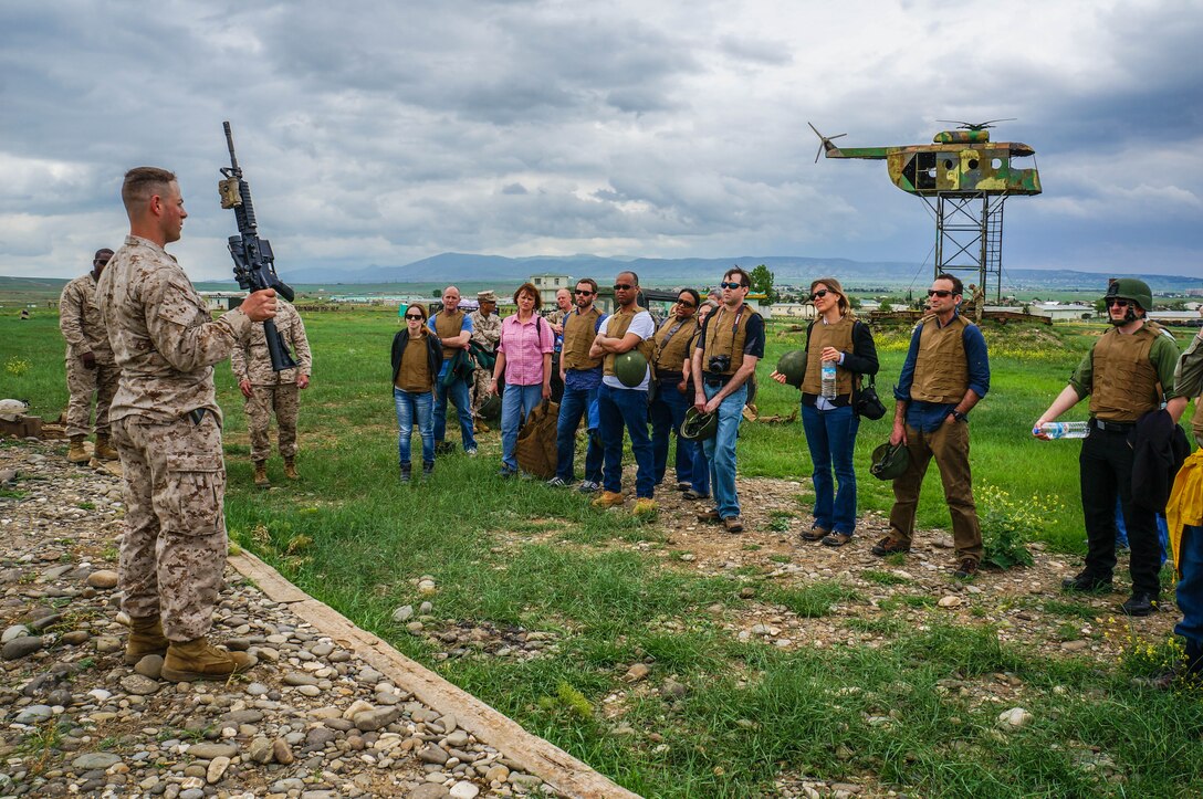 To prepare U.S. Embassy in Georgia staff members to fire the M4 carbine, Marines from the Georgia Deployment Program-ISAF introduce and demonstrate the function and procedures of the service rifle before a live-fire event during Embassy Training Day, May 8, outside of Tbilisi. To provide a snapshot into the lives of U.S. Marines and Georgian soldiers of the Georgian Deployment Program- ISAF, civilian embassy staff participated in basic-infantry experiences with an indoor night-vision course, riding an “MRAP,” or Mine-Resistant Ambush Protected vehicle, live-fire of the M4 carbine rifle, eating military rations, and observing a combat movement. 
