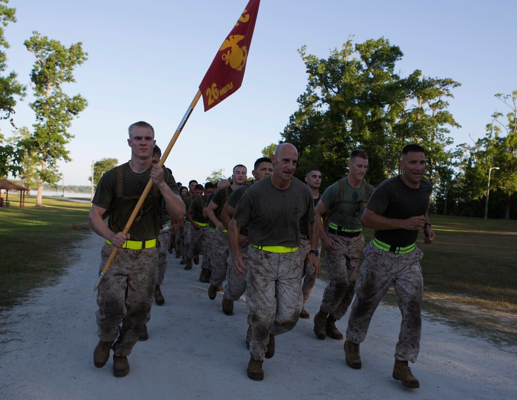 U.S. Marine Corps Col. Matthew G. St. Clair (center), 26th Marine Expeditionary Unit commanding officer (MEU), and Sgt. Maj. Scott M. Schmitt, 26th MEU command sergeant major (right), lead a formation run during a noncommissioned officer (NCO) led physical training session aboard Camp Lejeune, N.C., June 3, 2014. The training was designed to build camaraderie, morale, and allow NCOs an opportunity to expand their authority within the unit. (U.S. Marine Corps photo by Lance Cpl. Andre Dakis, 26th MEU Combat Camera/Released)