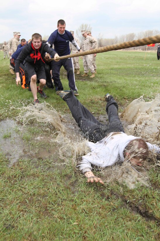 Brian Stoldt, a U.S. Marine Corps poolee from Perrysburg, Ohio, dives head first into a pool of water during a tug-of-war contest between two recruiting sub-stations, at Recruiting Station Detroit's all-hands pool function May 3, 2014. Stoldt, 18, currently attends Perrysburg High School. More than 350 Recruiting Station Detroit Marines and poolees from across the 14,000-square miles of southeastern Michigan and western Ohio participated in an annual pool function. For poolees this is an opportunity to put their physical and mental strength to the test and build camaraderie within their recruiting sub-station.  (U.S. Marine Corps photo by Sgt. Elyssa Quesada/Released)