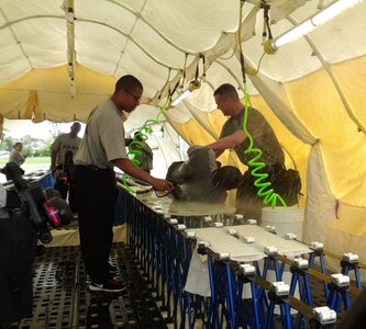 National Guard Soldiers of the Missouri Chemical, Biological, Radiological, Nuclear and high Explosive (CBRNE) Task Force simulate the decontamination process of a contaminated Soldier at Boone County Training Center (Missouri) May17, 2014. 