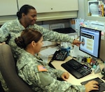 Assisted by Army Master Sgt. Denise Underwood from the 81st Regional Support Command, Army Sgt. Amanda Lockwood-Engel goes through the JAGCNet website, May 24, 2012, in order to determine whether or not she needs any assistance from the Staff Judge Advocate office. The website now has a function specifically for Army Reserve Soldiers and is accessible to all Army component service members.