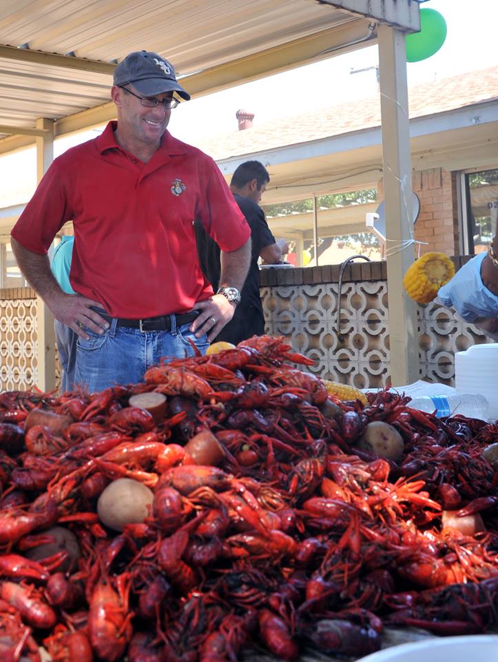Master Gunnery Sgt. Brian Comeaux, the operations chief for 8th Marine Corps District, prepares a crawfish dinner for residents at Arlington Villa Nursing and Rehab. Comeaux prepared 150 pounds of crawfish for the residents, many of which are former military members from the local area. (U.S. Marine Corps Photo by Lance Cpl. Alfred W. Dover)