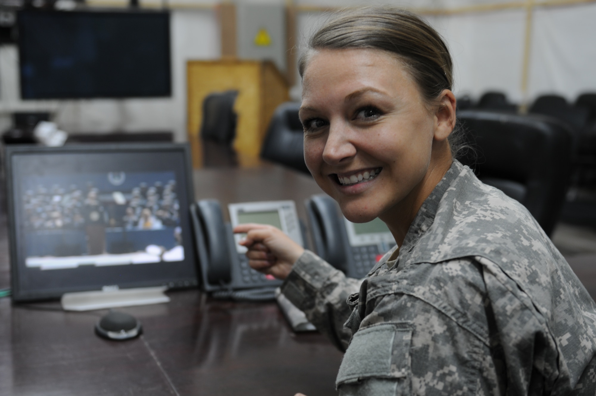 Capt. Brooke Jones watches a live stream of the U.S. Air Force Academy Graduation Ceremony May 28, 2014, from a conference room in Kuwait. Her younger brother, 2nd Lt. Blake Jones, graduated that day with the Class of 2014. (Courtesy Photo) 