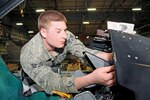 Air Force Senior Airman Sean Gilbert of the Vermont National Guard's 158th Fighter Wing Maintenance Squadron, performs a cockpit inspection February 2011.