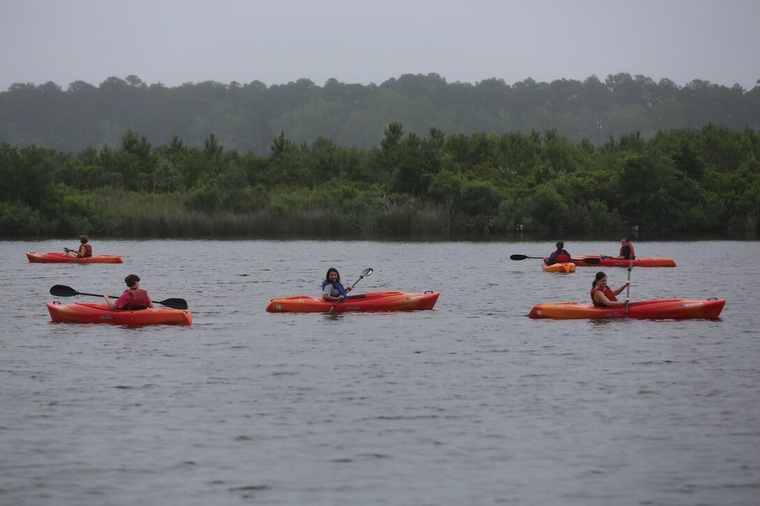 Marine spouses kayak in the Neuse River during Spouses Outdoor Exploration Day at Marine Corps Air Station Cherry Point, N.C., May 30, 2014. The event was hosted by Marine and Family Program's Marine Corps Family Team Building department. More than 50 spouses participated in the event. MCFTB is a program that provides educational resources and services to foster personal growth and enhance the readiness of service members and their families.  