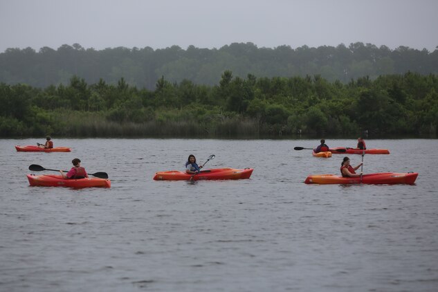 Marine spouses kayak in the Neuse River during Spouses Outdoor Exploration Day at Marine Corps Air Station Cherry Point, N.C., May 30, 2014. The event was hosted by Marine and Family Program's Marine Corps Family Team Building department. More than 50 spouses participated in the event. MCFTB is a program that provides educational resources and services to foster personal growth and enhance the readiness of service members and their families.  