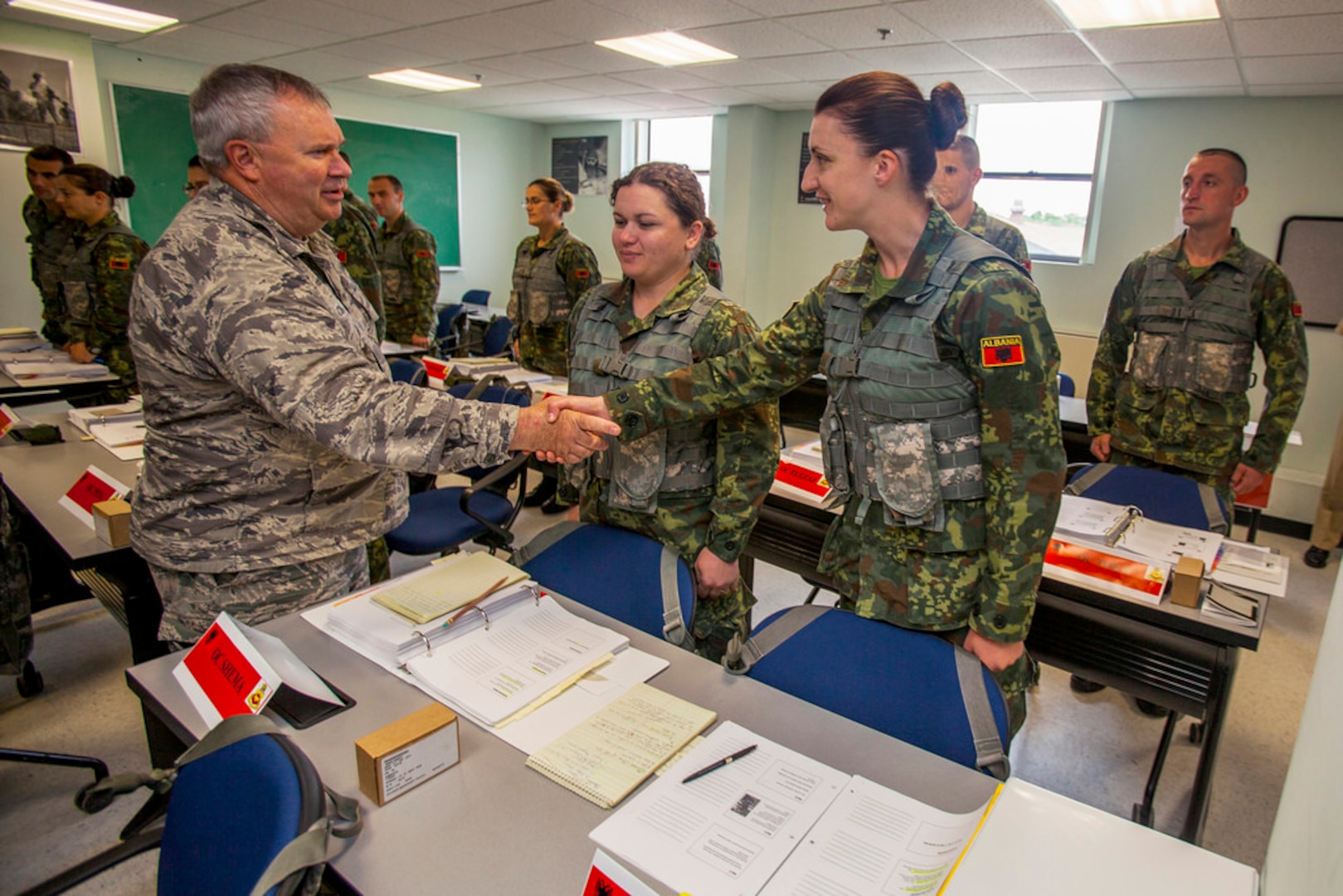 Brig. Gen. Michael L. Cunniff, New Jersey's adjutant general, greets Albanian Officer Candidate Renalda Manushi prior to ceremony where members of the Albanian Officer Candidate Class 001 transition from Phase One to Phase Two of the New Jersey Army National Guard OCS program with the awarding of the infantry blue ascot with the OCS roadwheel logo at Joint Base McGuire-Dix-Lakehurst, N.J., May 29, 2014. 
