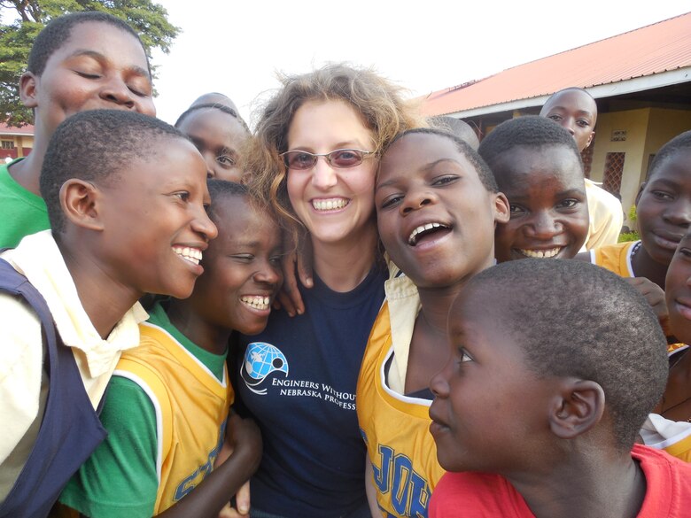 Students thank EWB-NE team member Jennifer Davis for the team's efforts. Following construction, the St. Kizito students took part in a celebration dance.