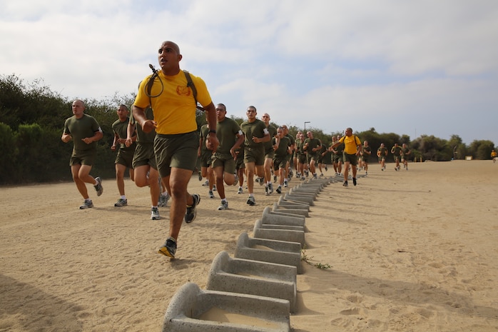 Recruits of Hotel Company, 2nd Recruit Training Battalion, run three quarter mile sprints before beginning the Circuit Course aboard the Marine Corps Recruit Depot San Diego, May 29. Drill instructor ran with the recruits as motivation to keep pushing themselves. 