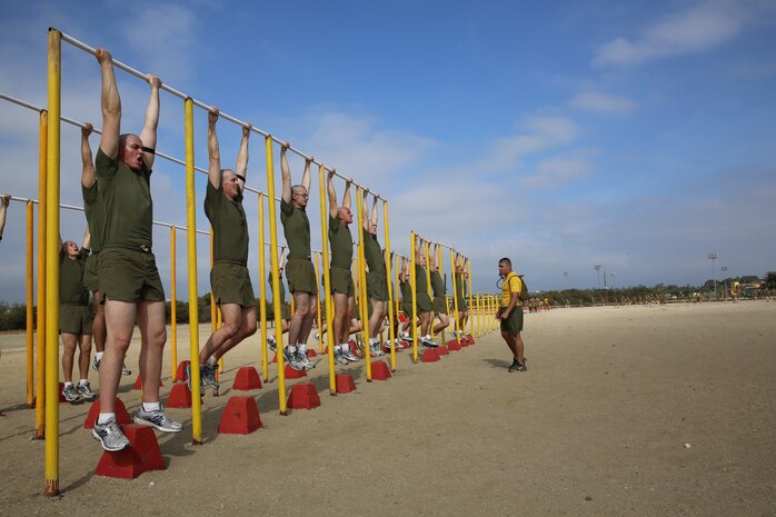 Recruits of Hotel Company, 2nd Recruit Training Battalion, conduct pull ups during a Circuit Course aboard the Marine Corps Recruit Depot San Diego, May 29. Before recruits began the course, they ran three quarter-mile sprints testing their maximum endurance.