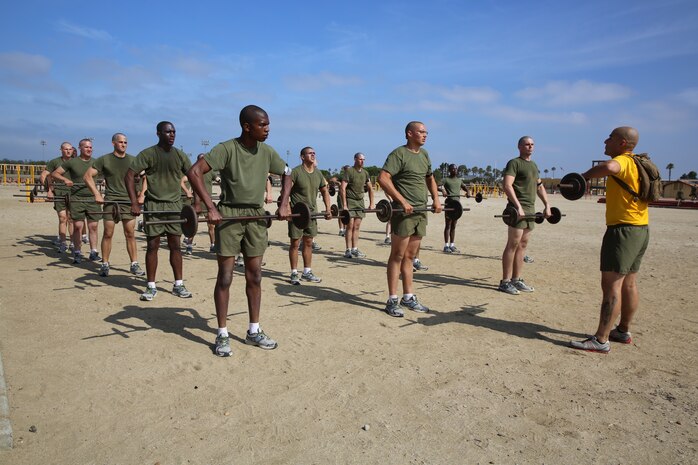 Recruits of Hotel Company, 2nd Recruit Training Battalion, perform bicep curls with their drill instructor during a Circuit Course aboard the Marine Corps Recruit Depot San Diego, May 29. If a recruit performed the technique wrong, a drill instructor corrected him and made sure he executed it correctly.