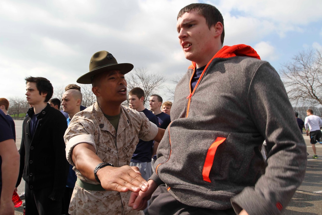U.S. Marine Corps Staff Sgt. Francis Sy, a Stockton, California native and a drill instructor with Kilo Company, 3rd Marine Corps Recruit Training Battalion, Marine Corps Recruit Depot Parris Island, South Carolina, directs Shane White, a poolee from Recruiting Sub-Station Pontiac, to raise his voice during Recruiting Station Detroit's annual pool function at Lake Erie Metropark, May 3, 2014. More than 350 Marines and poolees from across the 14,000-square miles of southeastern Michigan and western Ohio participated in the event.