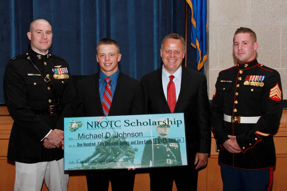 Michael Johnson, a resident of Tolland, Conn., and recent graduate of Tolland High School, is one of this year’s Naval Reserve Officer Training Corps Scholarship Program, Marine Corps Option, recipients. Capt. Thomas Abbott, the Executive Officer of Marine Corps Recruiting Station Springfield, Mass., presented Johnson with a $150,000 scholarship during a high school awards ceremony June 3, 2014, at the school. (Official U.S. Marine Corps photo by Sgt. Richard Blumenstein.)