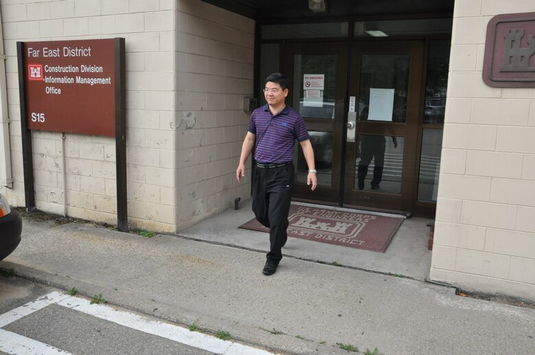 Sung Ho, mechanical engineer in construction division's quality assurance branch, leaves his office at the district's compound in Seoul, Korea. 