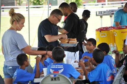 U.S. Army Capt. Jeffery Scott, command chaplain, and U.S. Army Spc. Sydney Stankee, along with other servicemembers serve lunch to the kids before taking them to watch a movie. Joint Task Force-Bravo’s Army Forces Battalion (ARFOR) hosted a fun-filled Saturday to 45 boys, and five adult chaperones from Horizontes al Futuro orphanage, May 31. The event was an opportunity for many ARFOR members to interact with the boys for the last time before departing Soto Cano. The kids and adults enjoyed a sandwich and chips lunch, as well as playing soccer, and dodge ball with the servicemembers. 