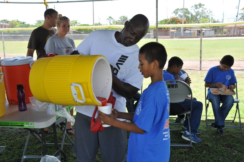 U.S. Army Chief Warrant Officer Albert Dixon gives a kid a glass full of juice during the luncheon for the Horizontes al Futuro boys. Joint Task Force-Bravo’s Army Forces Battalion (ARFOR) hosted a fun-filled Saturday to 45 boys, and five adult chaperones from Horizontes al Futuro orphanage, May 31. The event was an opportunity for many ARFOR members to interact with the boys for the last time before departing Soto Cano. The kids and adults enjoyed a sandwich and chips lunch, as well as playing soccer, and dodge ball with the servicemembers. 