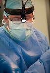 U.S. Air Force Maj. (Dr.) Forrest Jellison, urologist, works with his surgery team during a penectomy May 27, 2014, at the Karl Heusner Memorial Hospital in Belize City, Belize. A U.S. Air Force surgical team deployed to Belize for two weeks during a New Horizons Belize 2014 surgical readiness training exercise in coordination with the KHMH urologist and hospital staff. The urology surgery team conducted approximately 20 procedures during the training. (U.S. Air Force photo by Tech. Sgt. Kali L. Gradishar/Released)