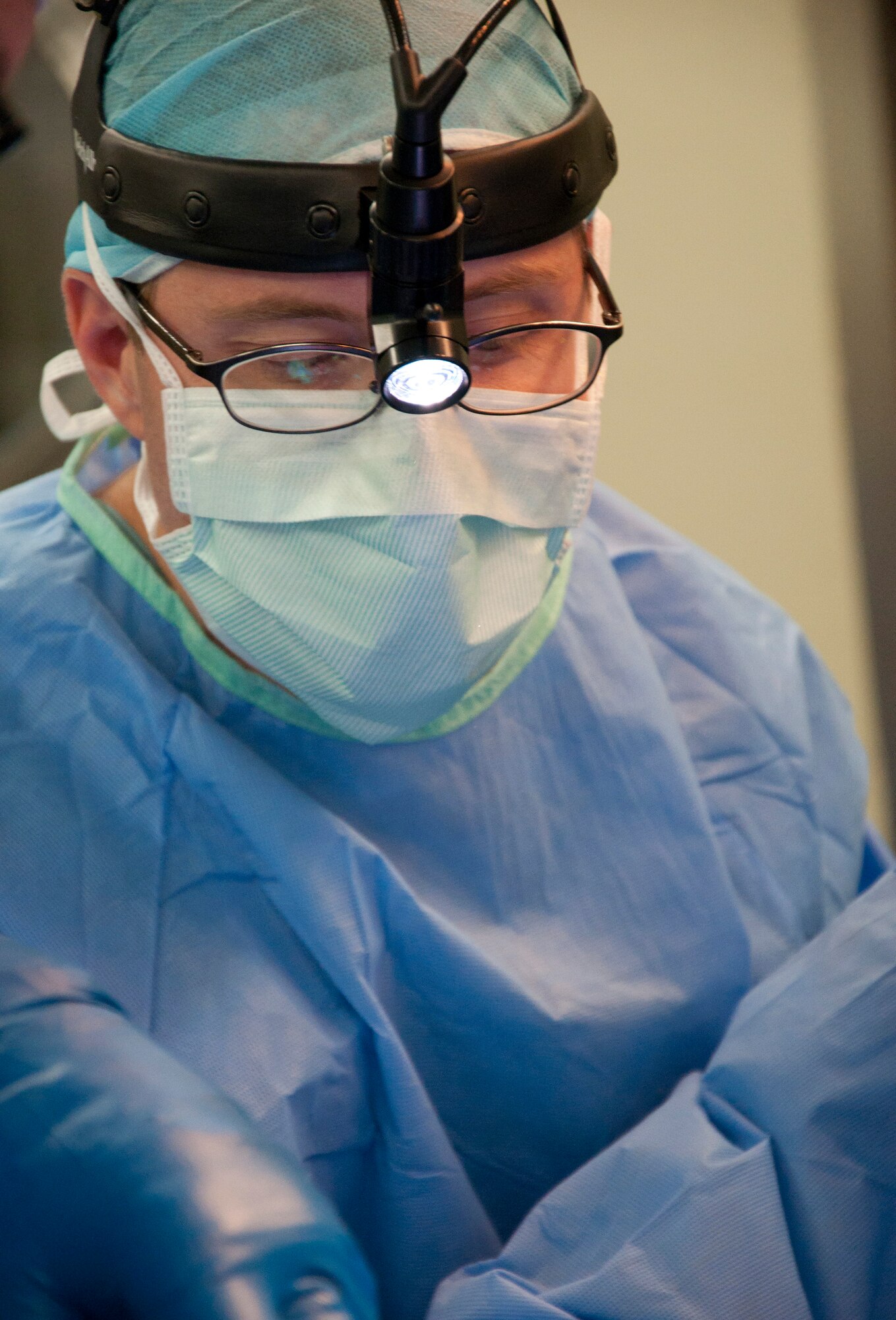 U.S. Air Force Maj. (Dr.) Forrest Jellison, urologist, works with his surgery team during a penectomy May 27, 2014, at the Karl Heusner Memorial Hospital in Belize City, Belize. A U.S. Air Force surgical team deployed to Belize for two weeks during a New Horizons Belize 2014 surgical readiness training exercise in coordination with the KHMH urologist and hospital staff. The urology surgery team conducted approximately 20 procedures during the training. (U.S. Air Force photo by Tech. Sgt. Kali L. Gradishar/Released)