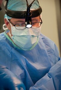 U.S. Air Force Maj. (Dr.) Forrest Jellison, urologist, works with his surgery team during a penectomy May 27, 2014, at the Karl Heusner Memorial Hospital in Belize City, Belize. A U.S. Air Force surgical team deployed to Belize for two weeks during a New Horizons Belize 2014 surgical readiness training exercise in coordination with the KHMH urologist and hospital staff. The urology surgery team conducted approximately 20 procedures during the training. (U.S. Air Force photo by Tech. Sgt. Kali L. Gradishar/Released)
