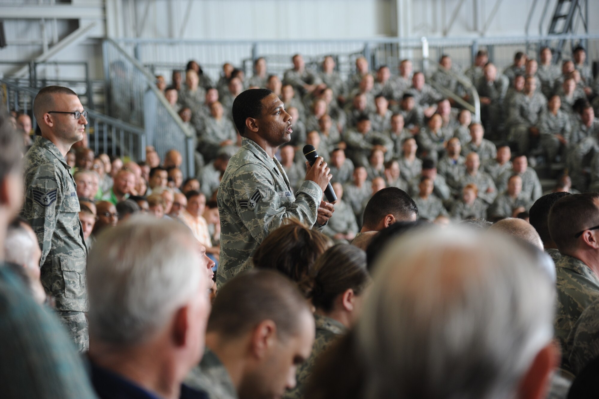Senior Airman Darius Golson, 2nd Air Force, asks the Secretary of the Air Force, Deborah Lee James, a question during an All Call James May 30, 2014, at the dual bay hangar at Keesler Air Force Base, Miss.  James also toured the Levitow Training Support Facility and the 403rd Wing. (U.S. Air Force photo by Kemberly Groue)