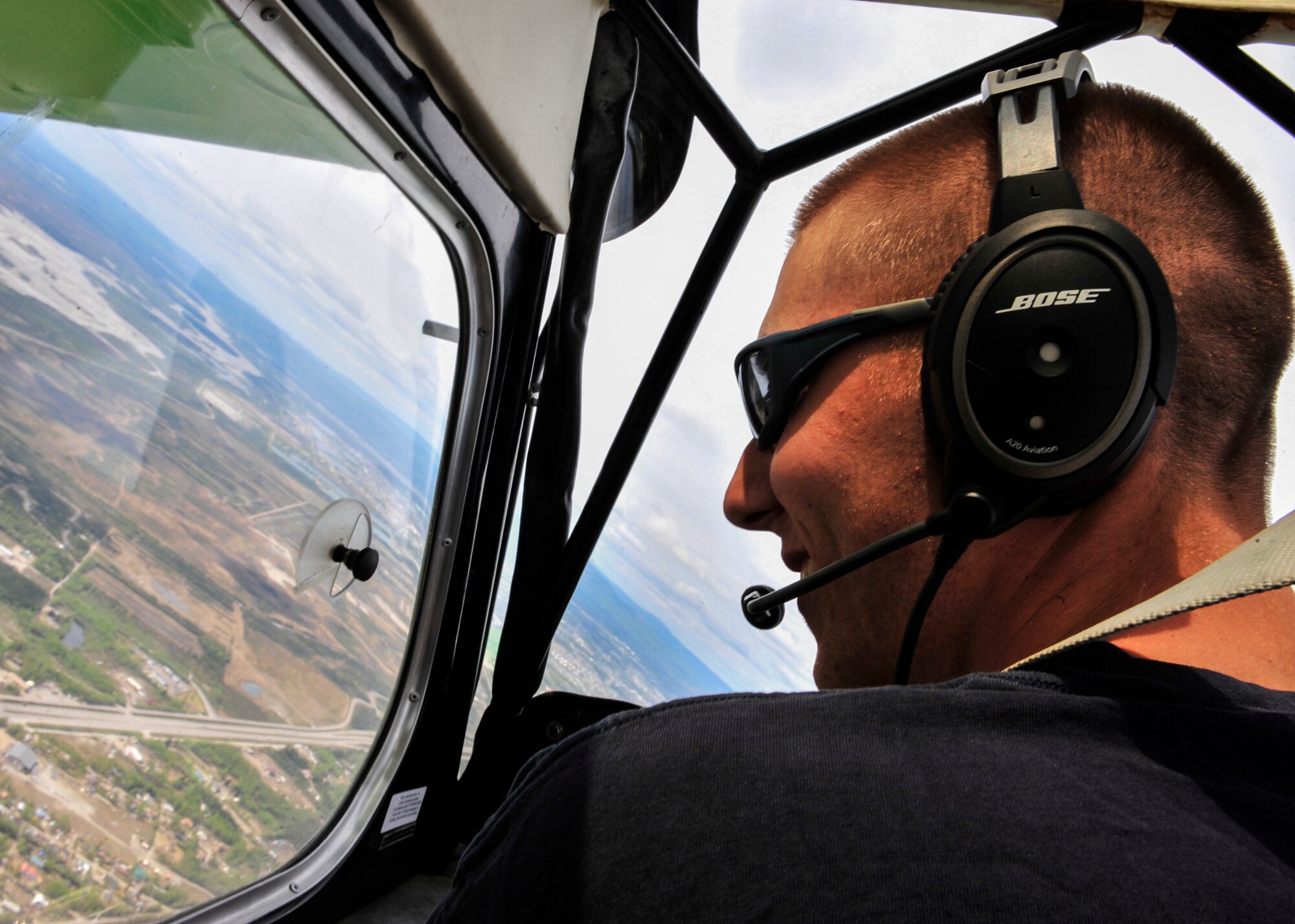 Senior Airman Alex Mumley-Dupuis, 354th Operations Support Squadron airfield management shift lead, flies his 1973 Citabria during Fairbanks Aviation Day May 17, 2014, Fairbanks, Alaska. Mumley-Dupuis is planning a 22-day flight to Oshkosh, Wis., in July to attend the AirVenture Air Show while spreading awareness for the Wounded Warrior Project. He hopes to raise $10,000 to give to the organization. (U.S. Air Force photo by Senior Airman Ashley Nicole Taylor/Released) 