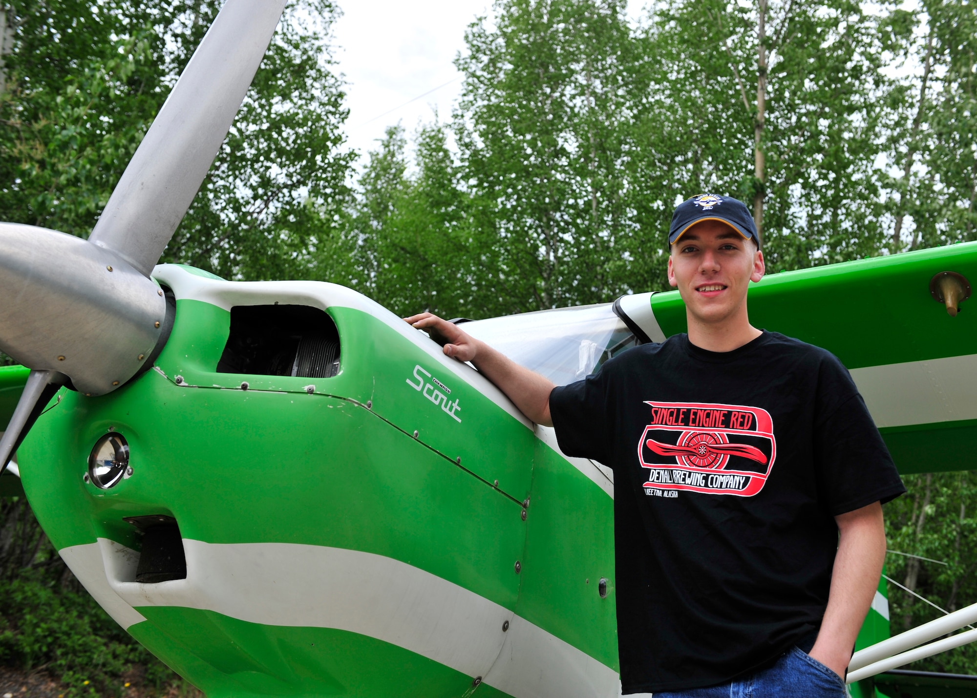 Senior Airman Alex Mumley-Dupuis, 354th Operations Support Squadron airfield management shift lead, stands in front of his 1973 Citabria June 1, 2014, North Pole, Alaska. Mumley-Dupuis is planning a 22-day flight to Oshkosh, Wis., in July to attend the Experimental Aircraft Association’s AirVenture Air Show while raising awareness for the Wounded Warrior Project. (U.S. Air Force photo by Senior Airman Ashley Nicole Taylor/Released)