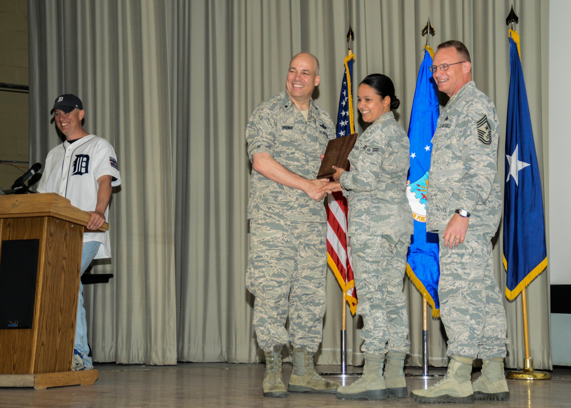 Airman 1st Class Raquel Caramanno, 412th Medical Group, receives her Airman of the Quarter Award from (left) Brig. Gen. Michael T. Brewer, 412th Test Wing commander, and Chief Master Sgt. Brian Randolph, 412th TW command chief. The first quarter awards ceremony was held at the base theater June 4. (U.S. Air Force photo by Rebecca Amber)

