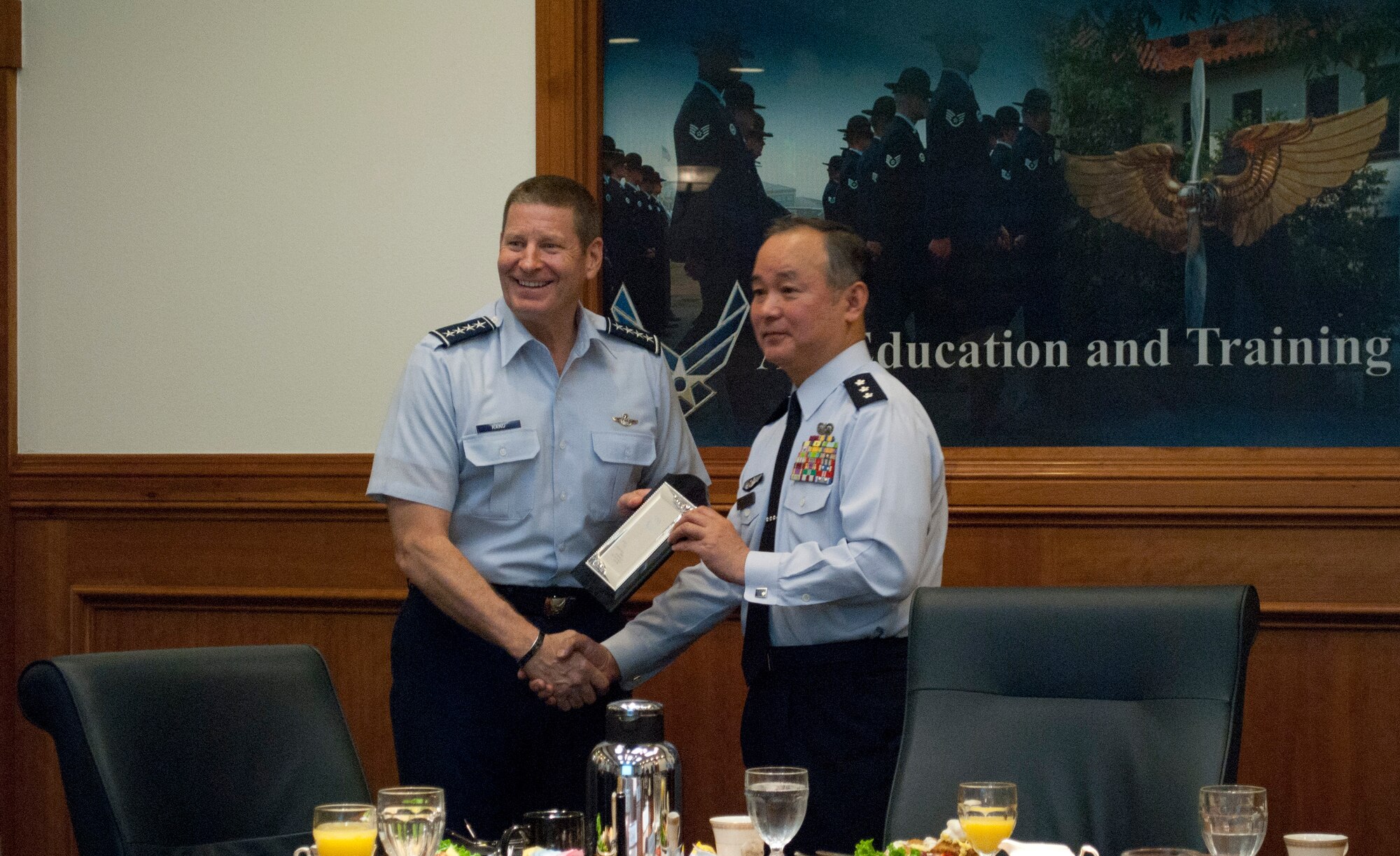 Gen. Robin Rand, commander of Air Education and Training Command, and Lt. Gen. Masayuki Hironaka, commander of the Air Training Command for the Japanese Air Self-Defense Force, Japan, exchanges tokens of appreciation. Hironaka visited units throughout Air Training and Education Command May 12, 2014. (U.S. Air Force photo by Capt. Ashley Walker)