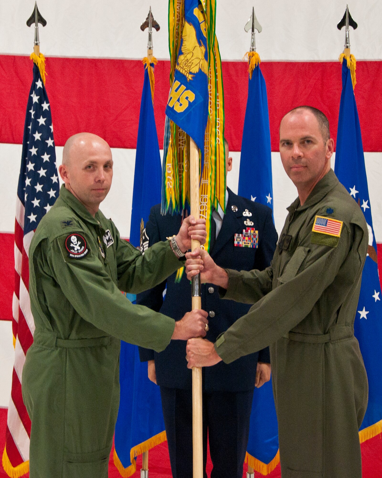 Col. Ronald Allen, Jr., 90th Operations Group commander, passes the 37th Helicopter Squadron guidon to Lt. Col. Todd Ivener as he assumes command of the squadron during a change-of-command ceremony June 2, 2014, in the helicopter hangar in Building 1250 on F.E. Warren Air Force Base, Wyo. Prior to his command, Ivener was the 37th HS's director of operations. (U.S. Air Force photo by Airman 1st Class Jason Wiese)