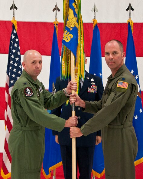 Col. Ronald Allen, Jr., 90th Operations Group commander, passes the 37th Helicopter Squadron guidon to Lt. Col. Todd Ivener as he assumes command of the squadron during a change-of-command ceremony June 2, 2014, in the helicopter hangar in Building 1250 on F.E. Warren Air Force Base, Wyo. Prior to his command, Ivener was the 37th HS's director of operations. (U.S. Air Force photo by Airman 1st Class Jason Wiese)