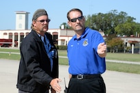 Geren Fawver (right), a 12th Operations Support Squadron airfield manager, talks with contractor Randall Schow about restriping the flightline ramp May 16 at Joint Base San Antonio-Randolph. (U.S. Air Force photo by Johnny Saldivar)

