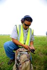 Michael Pacheco, 12th Flying Training Wing wildlife biologist and airport operations, makes sure his weapon is clear before packing it in his bag May 16 at Joint Base San Antonio-Randolph. (U.S. Air Force photo by Airman 1st Class Kenna Jackson)


