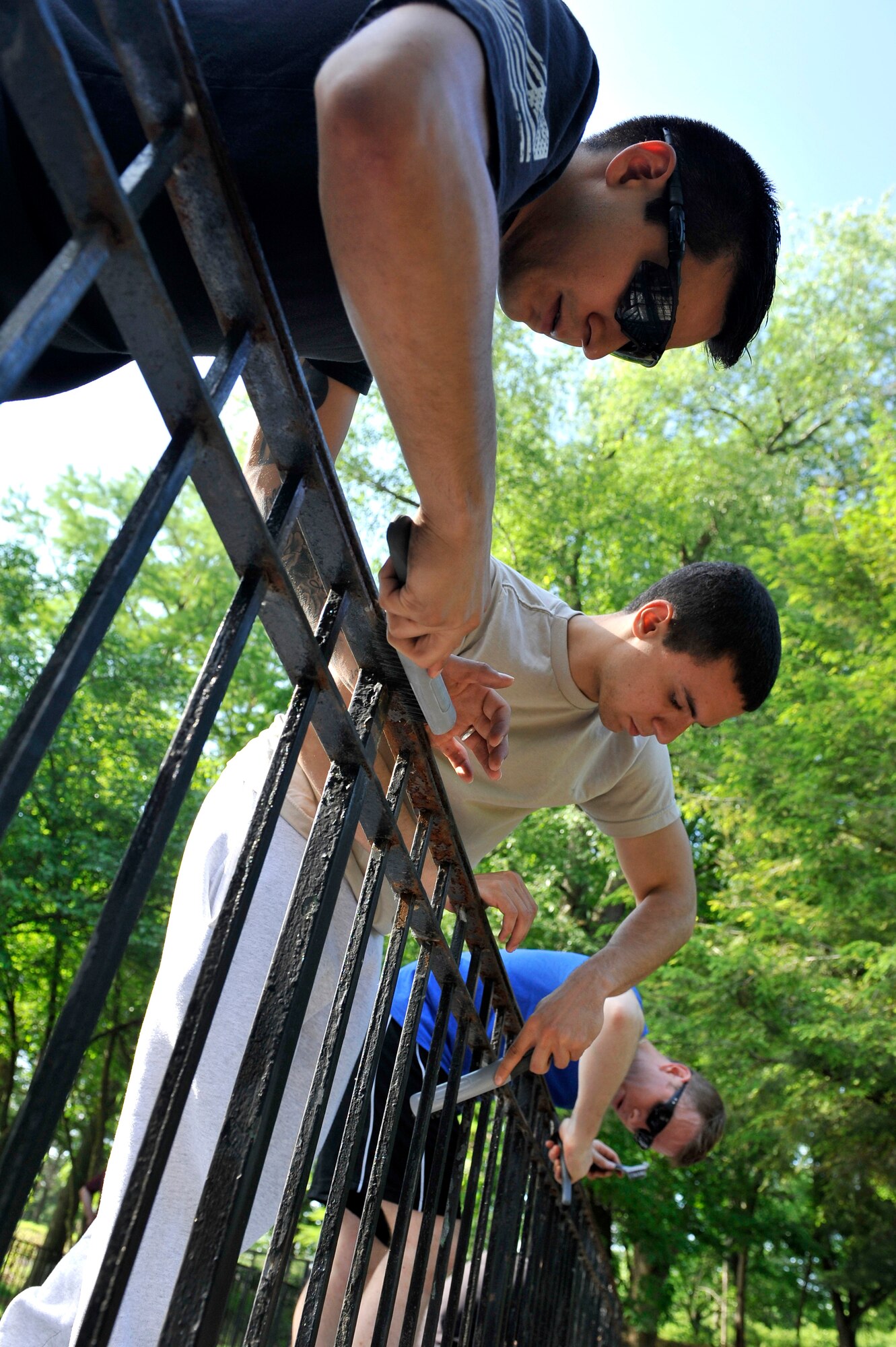 Members of the 375th Operations Support Squadron take a couple hours out of work to paint fences May 30, 2014 in St. Louis. The unit has also donated items to the humane society, giving trees, and families in need. In 2013, the 375th OSS commander decided to start a program for the squadron to begin volunteering monthly. Some previous events included: Belleville Humane Society, St. Louis Food Bank, and the Missouri Veterans Home. (U.S. Air Force photo/Airman 1st Class Kiana Brothers)