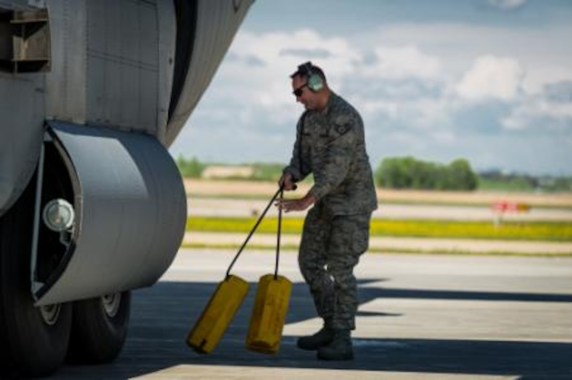 U.S. Air Force Staff Sgt. William Hutchins, C-130 Hercules crew chief with the 94th Airlift Wing, Dobbins Air Reserve Base, Ga., pulls chocks during Maple Flag in Edmonton/Cold Lake, Alberta, Canada, May 27, 2014. Maple Flag is an international exercise designed to enhance the interoperability of C-130 aircrews, maintainers and support specialists in a simulated combat environment. (U.S. Air Force photo by Master Sgt. John R. Nimmo, Sr./Released)
